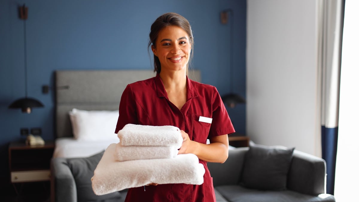 Professional cleaner preparing a hotel room
